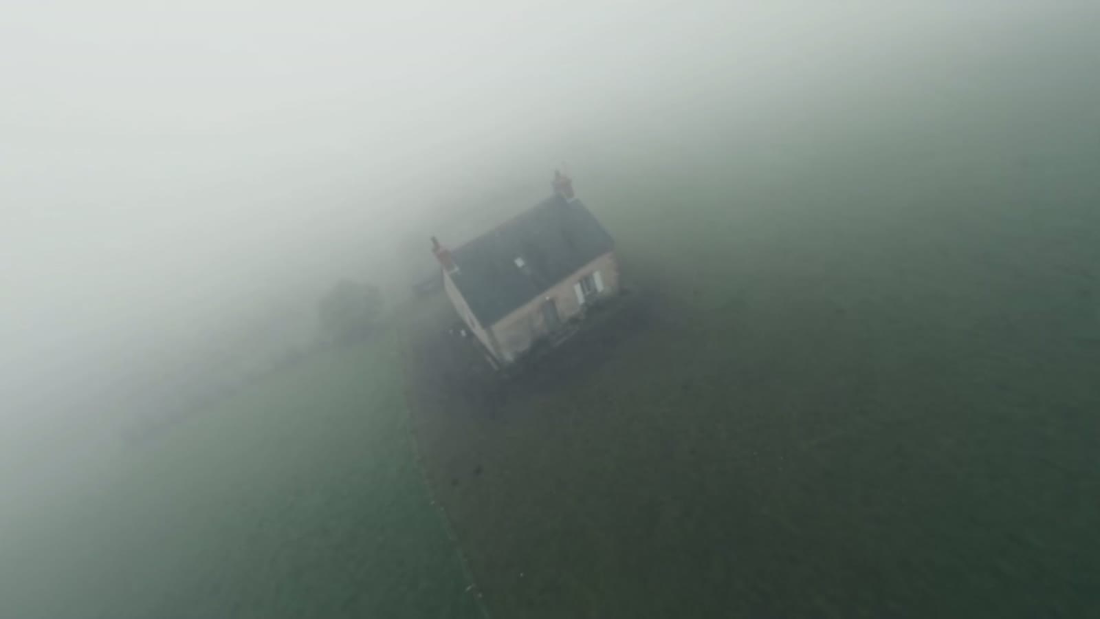 La maison isolée dans le brouillard, plan d'ambiance en vue aérienne