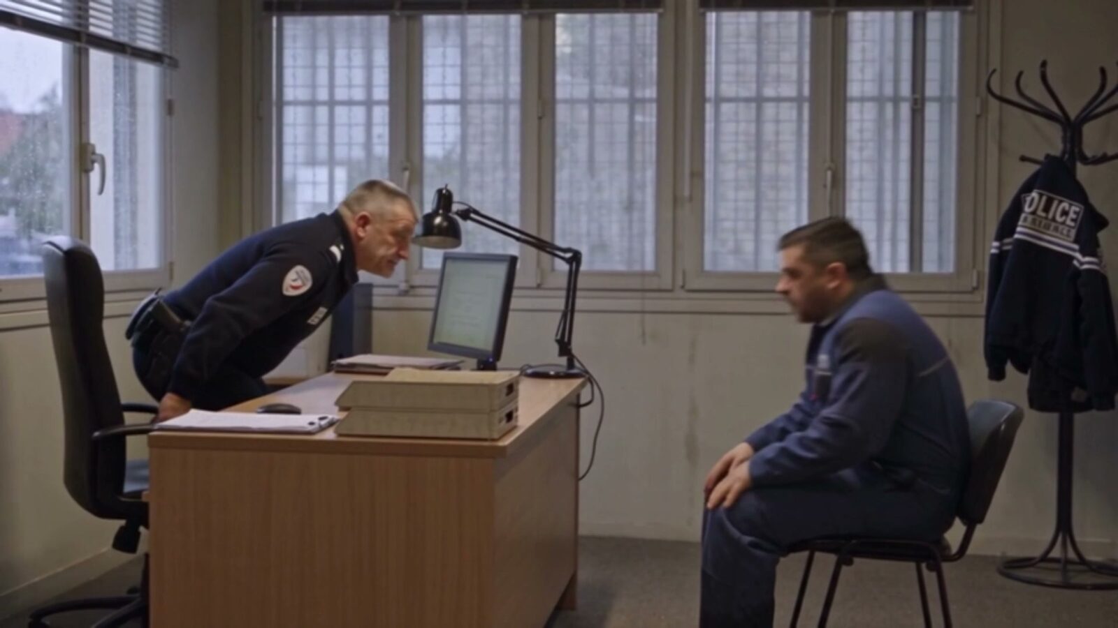 Au commissariat, le père assis face au bureau d'un policier